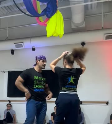 Inna dancing with a partner in the studio